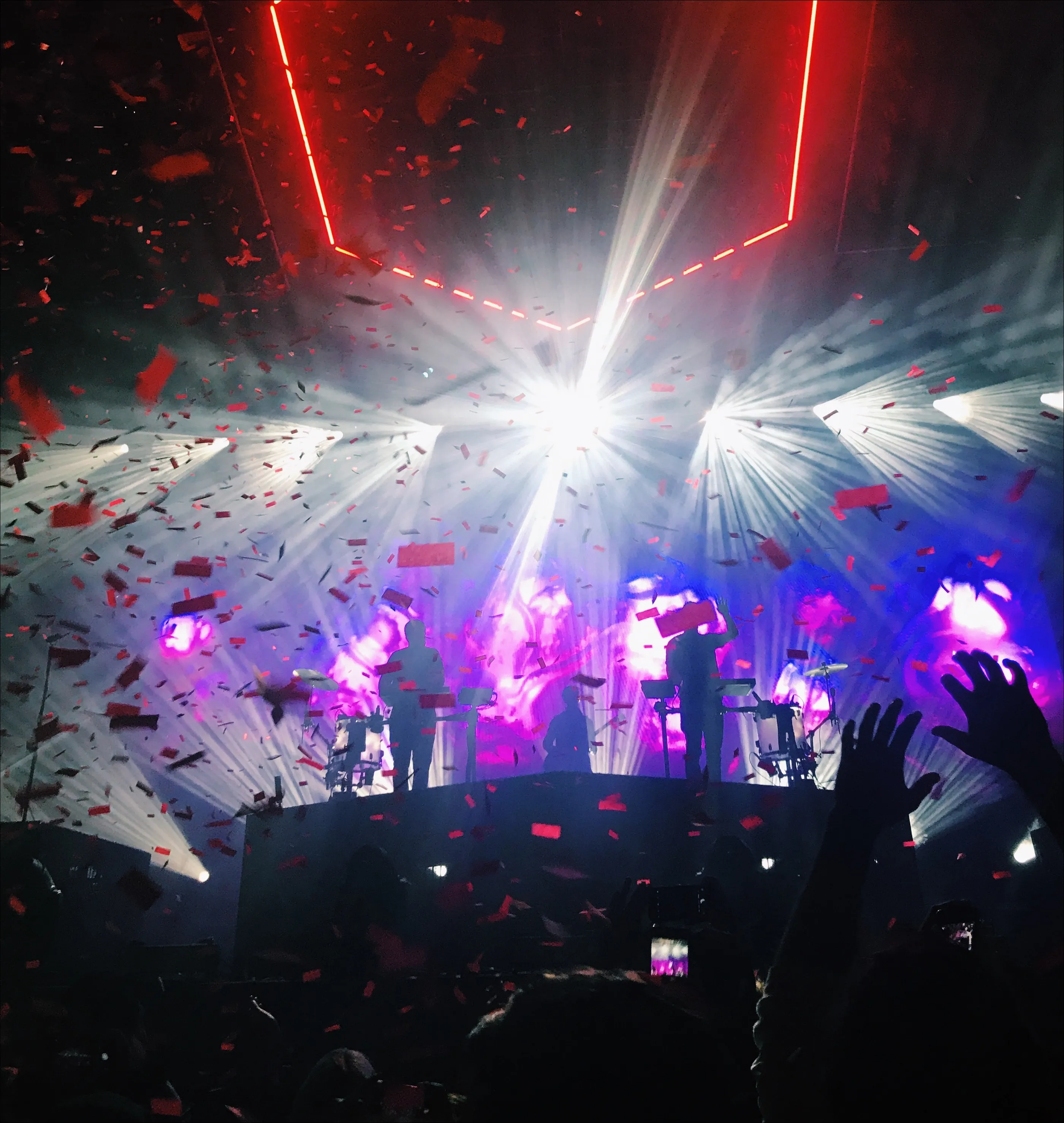ODESZA performing under a red hexagon light rig